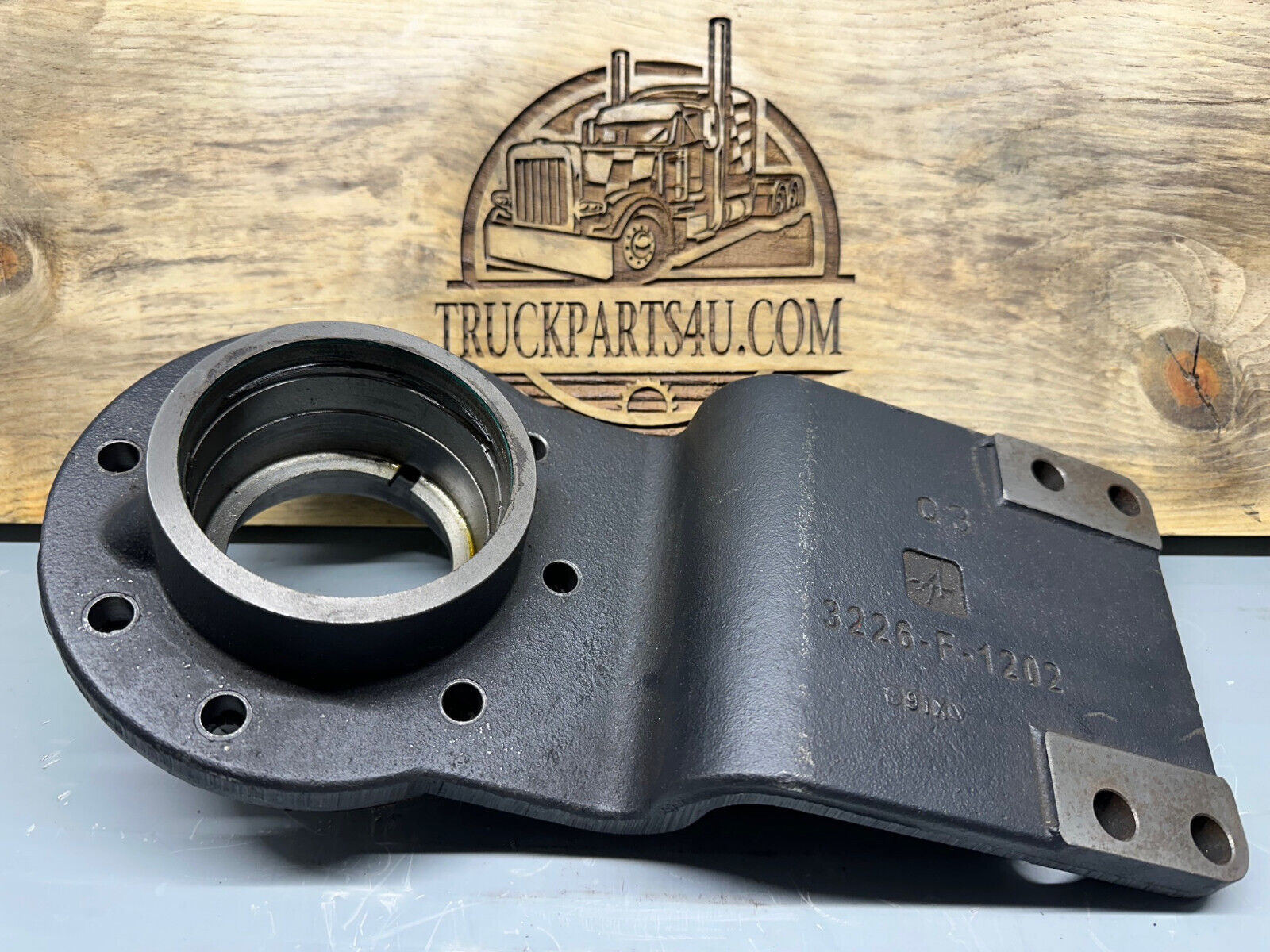 Meritor 3226G1203 differential carrier bracket / input bearing retainer F106. Showing casting number 3226G1202